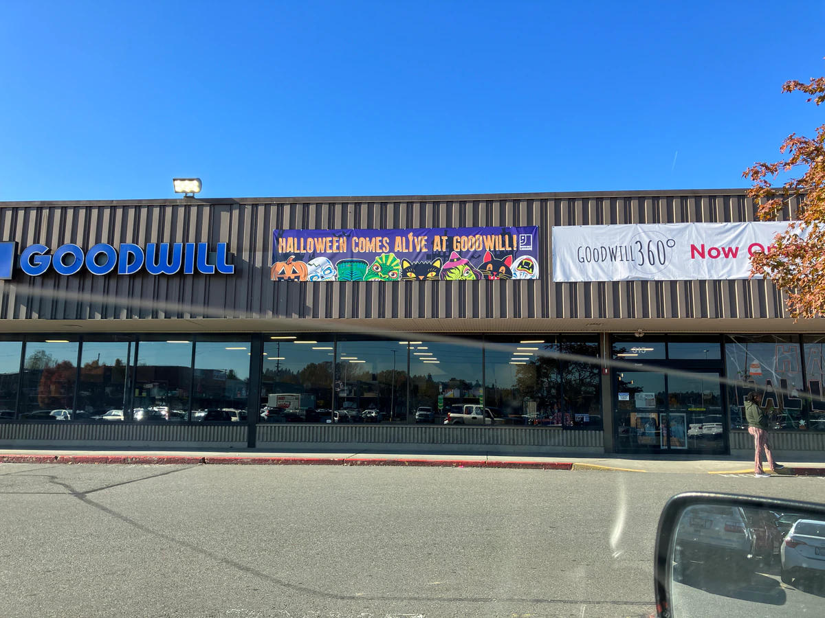 Kent Goodwill in Kent, Washington, a Goodwill thrift store showing neatly organized clothing racks and household goods.