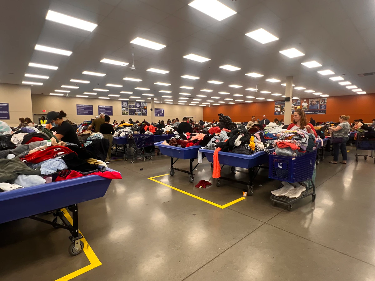 Romeoville Goodwill Outlet in Romeoville, Illinois, featuring shoppers searching through bulk textile containers.