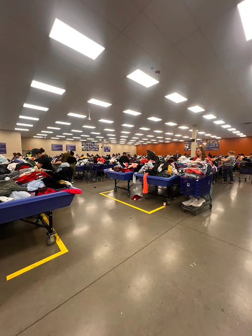 Romeoville Goodwill Outlet in Romeoville, Illinois, highlighting organized racks of clothing near the checkout area.