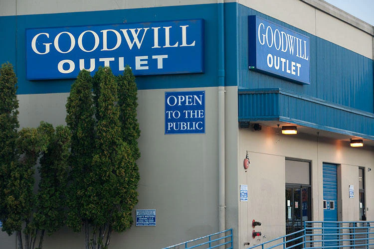 Seattle Outlet Goodwill in Seattle, Washington, showing blue rolling bins filled with discounted merchandise.