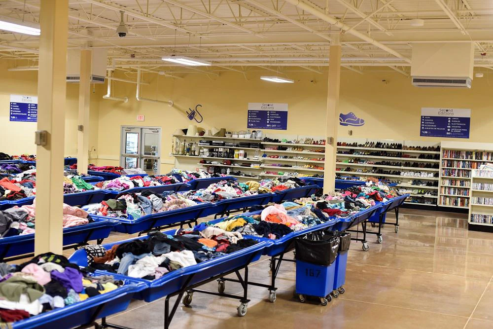 Second Editions (Goodwill Outlet), a Goodwill outlet store highlighting organized racks of clothing near the checkout area..