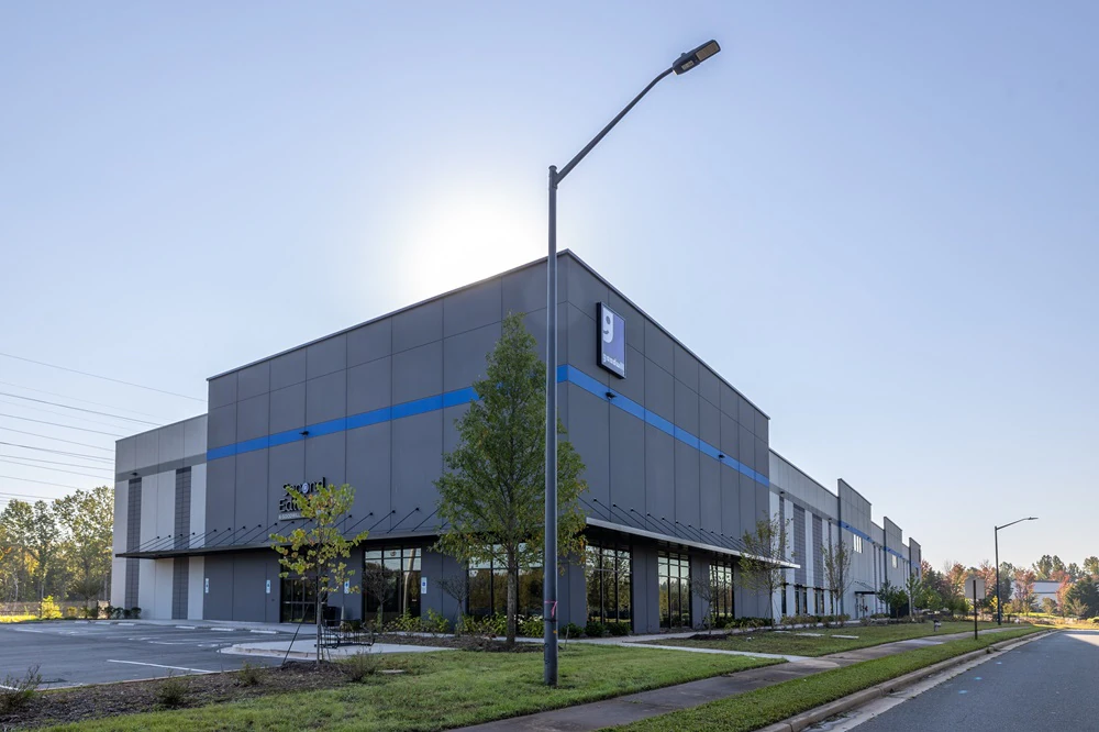 Second Editions - Rock Hill (Goodwill Outlet), a Goodwill outlet store featuring shoppers searching through bulk textile con.