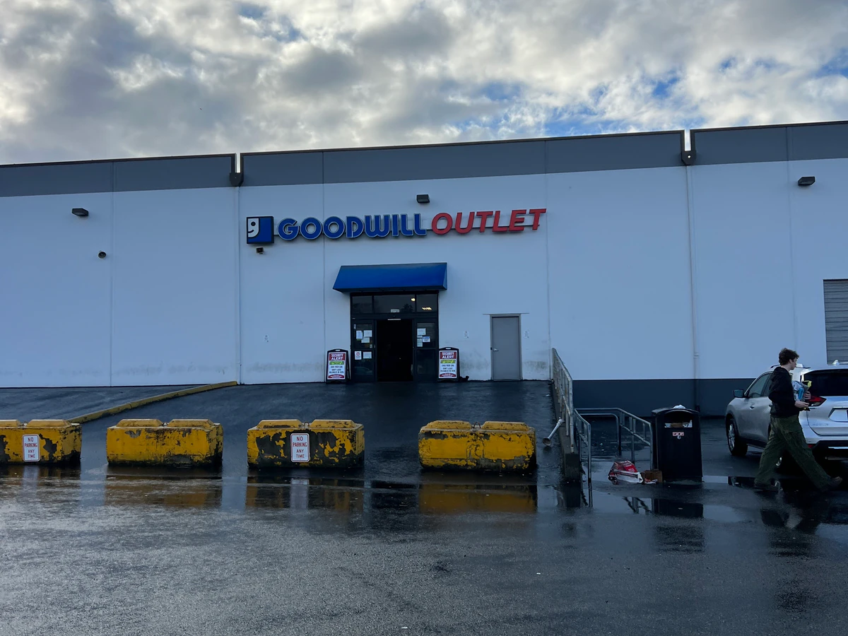 Tacoma Goodwill Outlet in Tacoma, Washington, showing blue rolling bins filled with discounted merchandise.