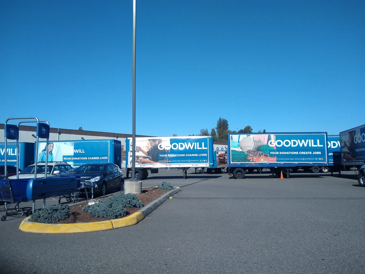 Tacoma Goodwill Outlet in Tacoma, Washington, featuring shoppers searching through bulk textile containers.