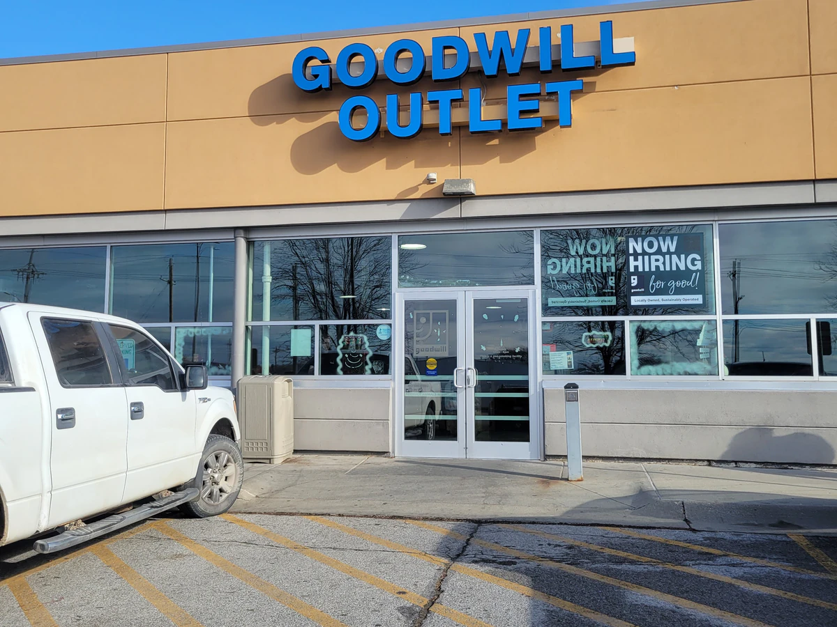 The Goodwill Outlet in Omaha, Nebraska, a Goodwill outlet store showing blue rolling bins filled with discounted merchandise.