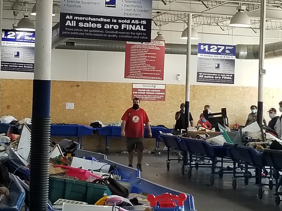The Goodwill Outlet in Omaha, Nebraska, a Goodwill outlet store featuring shoppers searching through bulk textile containers.