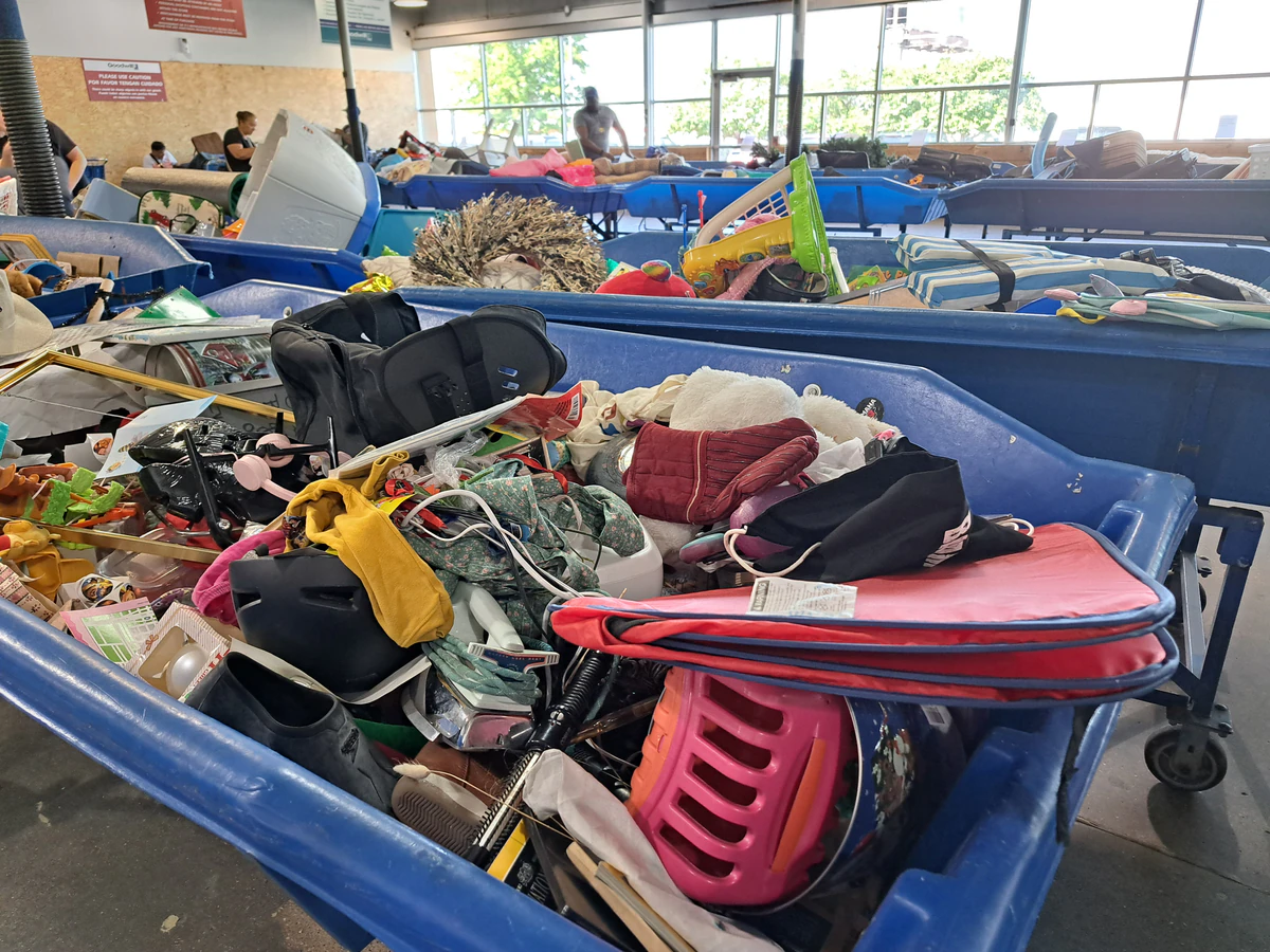 The Goodwill Outlet in Omaha, Nebraska, highlighting organized racks of clothing near the checkout area.