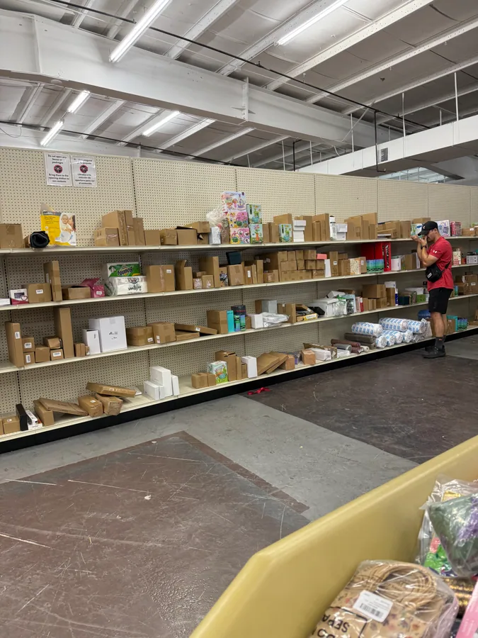 Inside Wizard Bins & Auctions bin store in Portsmouth, VA showing liquidation bins and bargain finds.